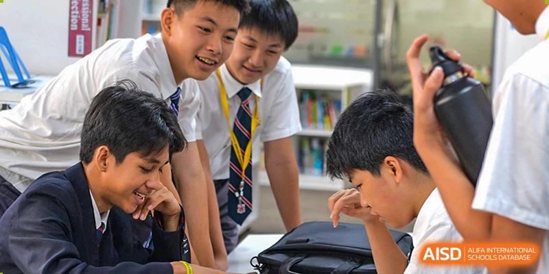 Students from Dulwich College Suzhou are collaborating on a project in the library.