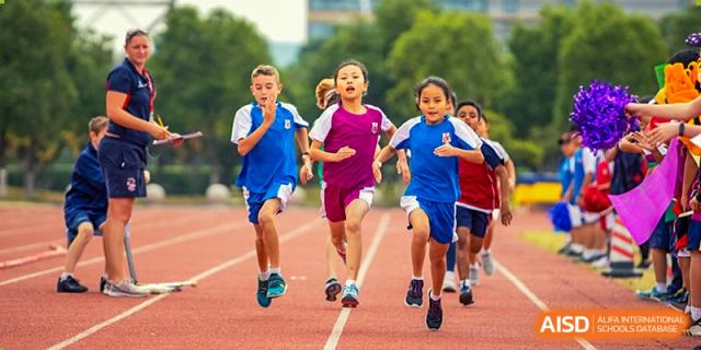Students from Dulwich College Suzhou participate in a running race on a track.