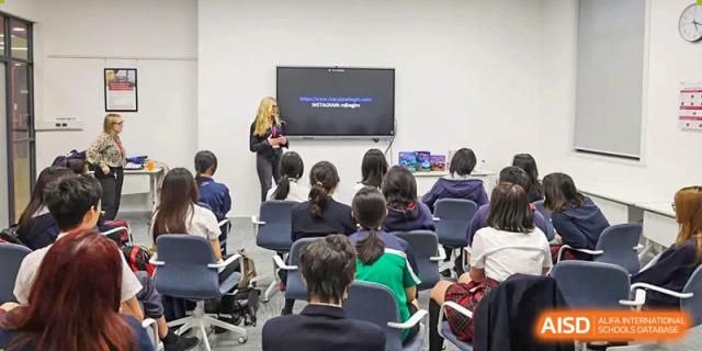 A group of students from Dulwich International Suzhou High School Programme sitting in a classroom, listening to a presentation.