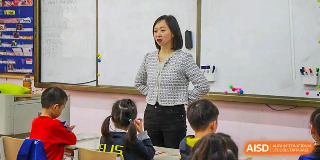 A female teacher instructing her students in a classroom at Fuzhou Lakeside International School.