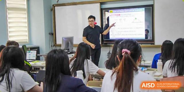 A teacher presenting a lesson using a large digital screen to students at Fuzhou Lakeside International School.