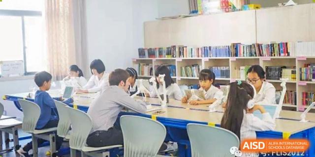 Students studying or collaborating at a table in the library at Fuzhou Lakeside International School.