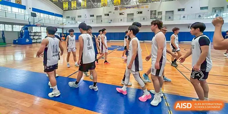 A boys' basketball team walking on the court during a game or practice at Fuzhou Lakeside International School.