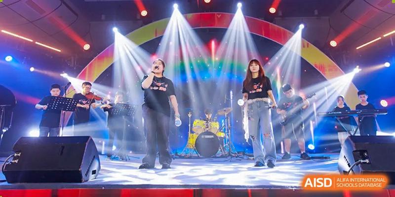 A band performing on a stage with a drum set at Fuzhou Lakeside International School.