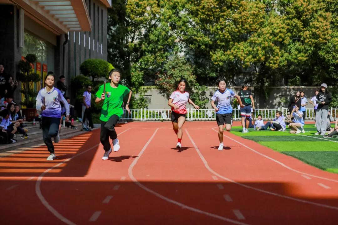 Students participating in a running race on the track at Fuzhou Lakeside International School.