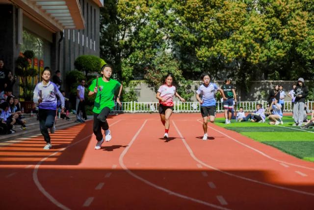 Students participating in a running race on the track at Fuzhou Lakeside International School.