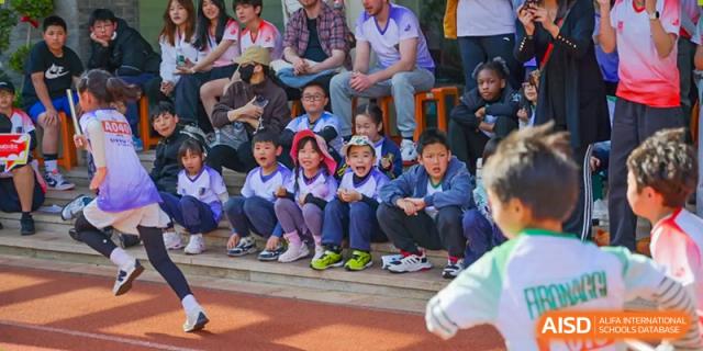 A group of students from a sports team sitting together on the bleachers at Fuzhou Lakeside International School.