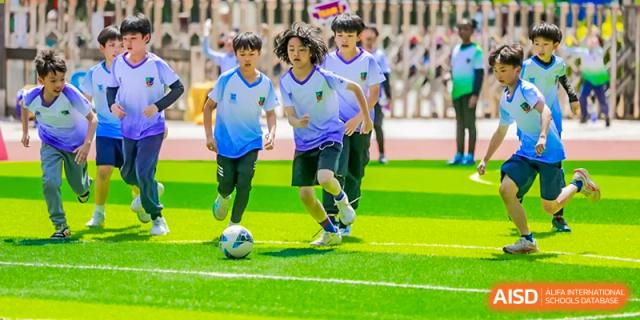 A close-up of students' feet playing soccer on the field at Fuzhou Lakeside International School.