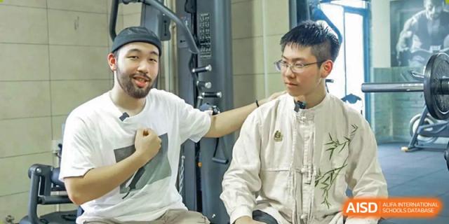 A teacher or coach encouraging a student during a workout session at Fuzhou Lakeside International School.