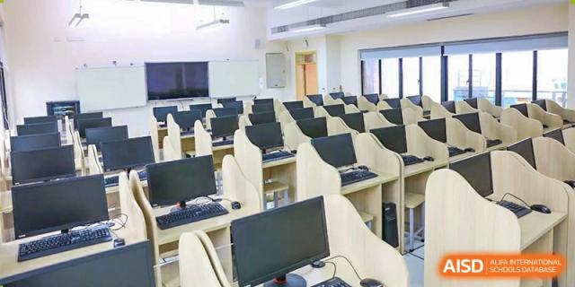 A computer lab at HAILIANG FOREIGN LANGUAGE SCHOOL with many desks and monitors.