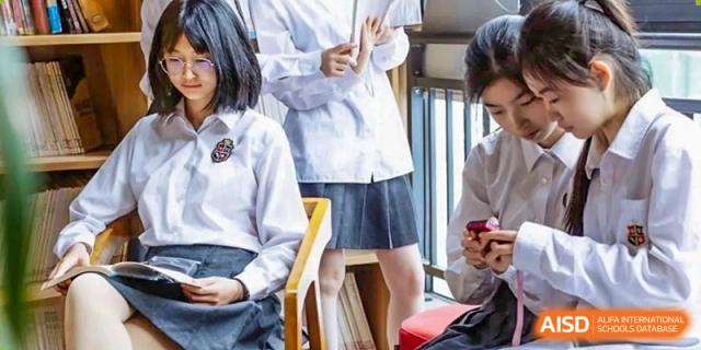 A student at HAILIANG FOREIGN LANGUAGE SCHOOL looks on as a teacher gives an explanation in class.