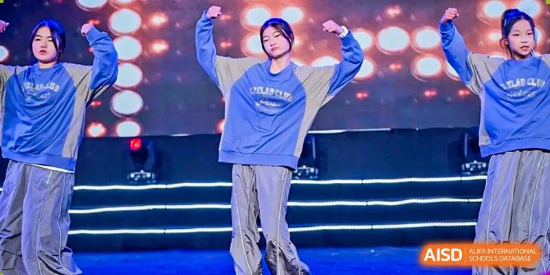 A student at HAILIANG FOREIGN LANGUAGE SCHOOL performs a street dance routine on a stage.