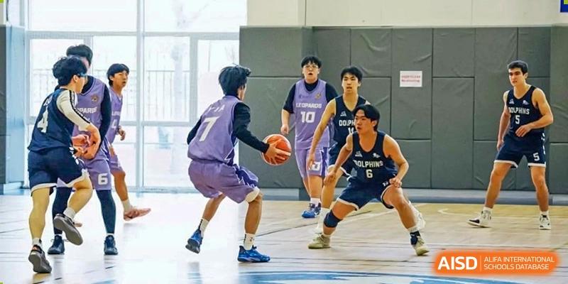 A basketball player dribbles the ball on the court at the International School of Qingdao.