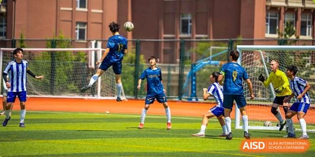 A student jumps to head a soccer ball during a game at the International School of Qingdao.