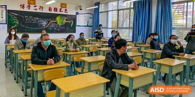 Students seated at their desks in a classroom, listening to a lesson at the International Department of Kunming No.10 Middle School.