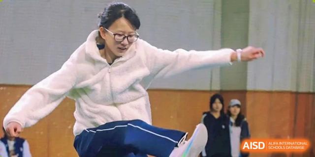 A student jumping during a high jump or long jump event at the International Department of Kunming No.10 Middle School sports day.