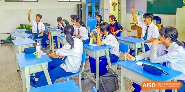 Students seated at their desks, focusing on a lesson at Kunming World Youth Academy.