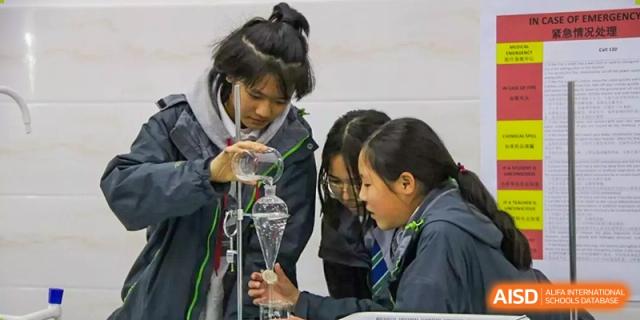 Students conducting a science experiment in a lab at Kunming World Youth Academy.