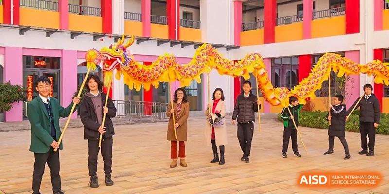 Students participating in a cultural parade at Kunming World Youth Academy.