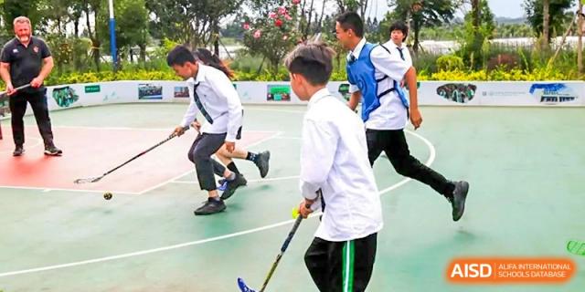 Students playing floorball, a team sport, at Kunming World Youth Academy.