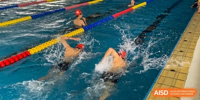 A student swimming laps in a pool at Kunming World Youth Academy.