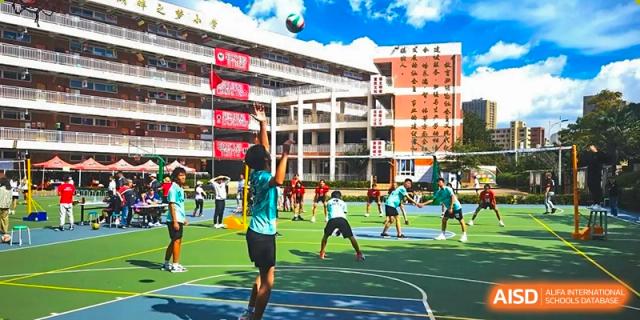 A student participating basketball in a field sport at Kunming World Youth Academy.