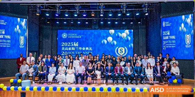 A large group photo of students and staff seated on a stage with a digital backdrop for a 2025 event at Weiming International Qingdao.