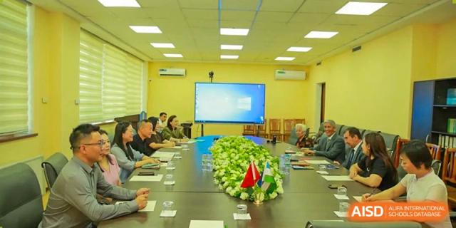 Teachers and parents from Sanya Haiya  Foreign Language School in a meeting room with a large screen.