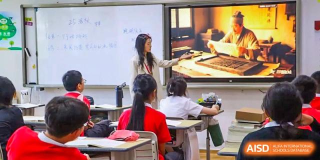 A teacher from Sanya Haiya  Foreign Language School using a smart board to give a lesson to students.