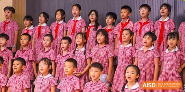 Students from Sanya Haiya  Foreign Language School singing together as a choir in uniform.