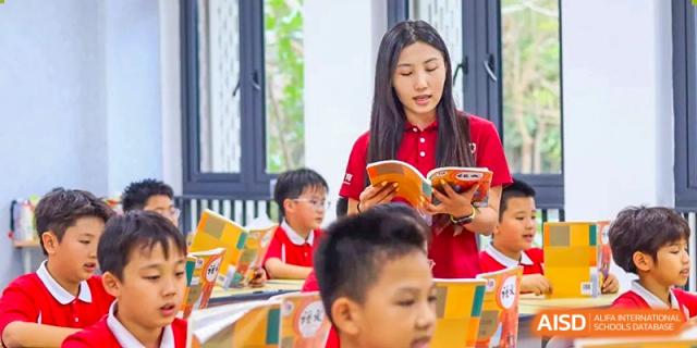 A teacher from Sanya Haiya  Foreign Language School reading to students in a classroom.