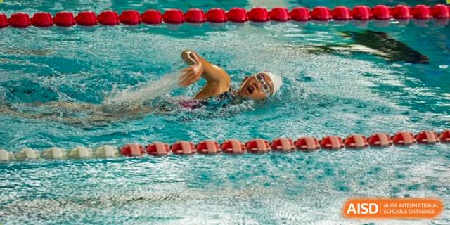 A swimmer from Sanya Haiya  Foreign Language School doing the breaststroke in a competition.