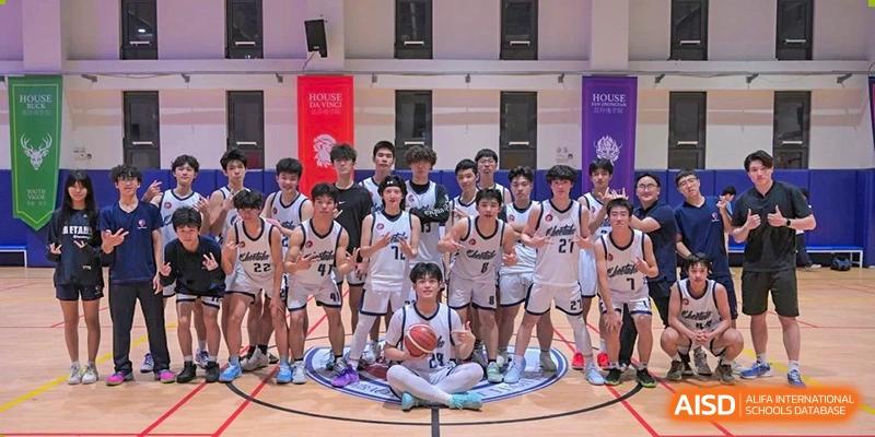 A group of basketball players from Shanghai Qibao Dwight High School pose for a team photo on the court.