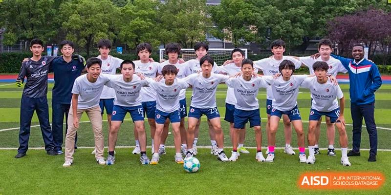 The Shanghai Qibao Dwight High School boys' soccer team poses for a group photo on the field.