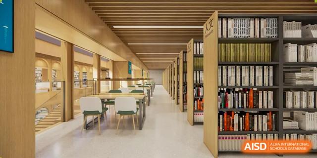A well-organized, empty library with rows of bookshelves and study desks at Sino-Canada School.