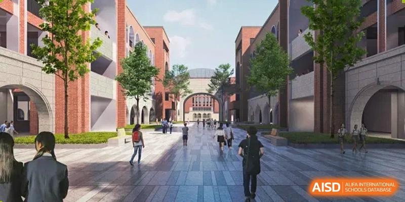 People walking along a wide, brick pathway between large, red brick buildings at Sino-Canada School.