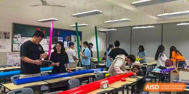 Students from Suzhou Experimental High School International Center work on a group project in a classroom.