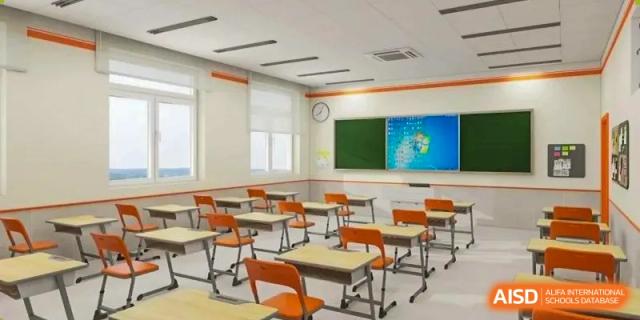 An empty classroom with desks, chairs, and a whiteboard at The MacDuffie School Tianjin.
