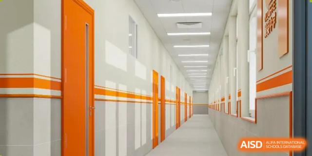 A long hallway with orange stripes on the walls at The MacDuffie School Tianjin.