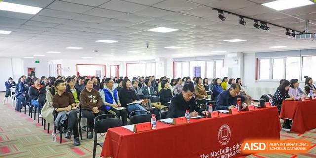 A group of students are attending a meeting or presentation at The MacDuffie School Tianjin.