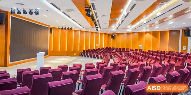 An auditorium with empty seats is ready for an event at The MacDuffie School Tianjin.