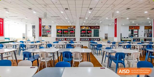 A clean, empty dining hall with tables and chairs at The MacDuffie School Tianjin.