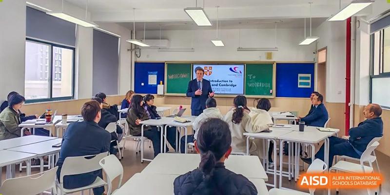 An academic class at Zhejiang Wenzhou High School International Division where a teacher stands by a whiteboard, lecturing to students seated at desks.