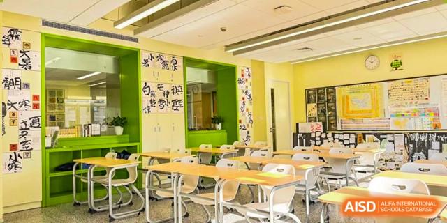 An empty modern classroom at YK Pao School with a colorful, decorated wall.