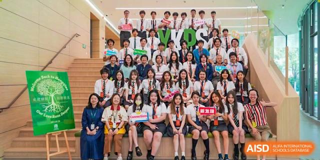 A large group of students from YK Pao School posing for a group photo together.