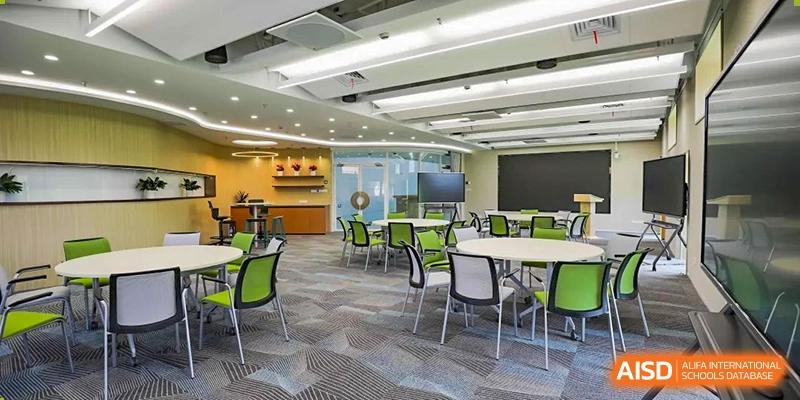 A student collaboration space at YK Pao School with small tables and chairs in a modern, well-lit room.