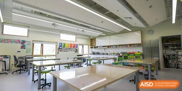 A clean, spacious science classroom or lab at YK Pao School with a long wooden table.