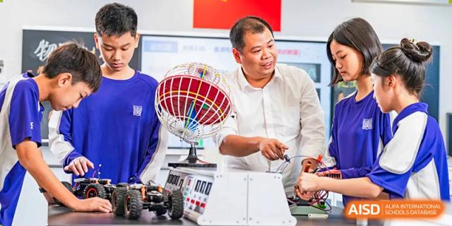 A man in a white polo shirt with an open-faced globe. Guangzhou International Primary/Middle School Huangpu