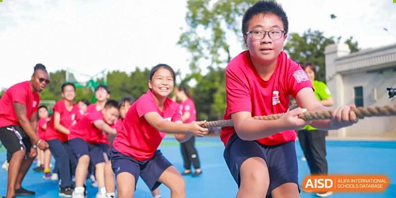 Two children play tug of war. Guangzhou International Primary/Middle School Huangpu