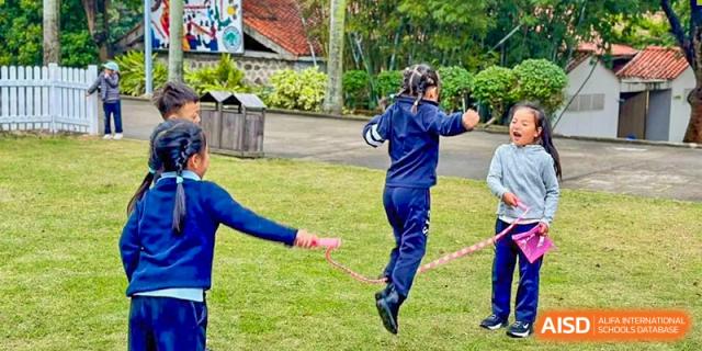 A student from Zhuhai Qiao International School participating in an outdoor physical education class, actively jumping rope.